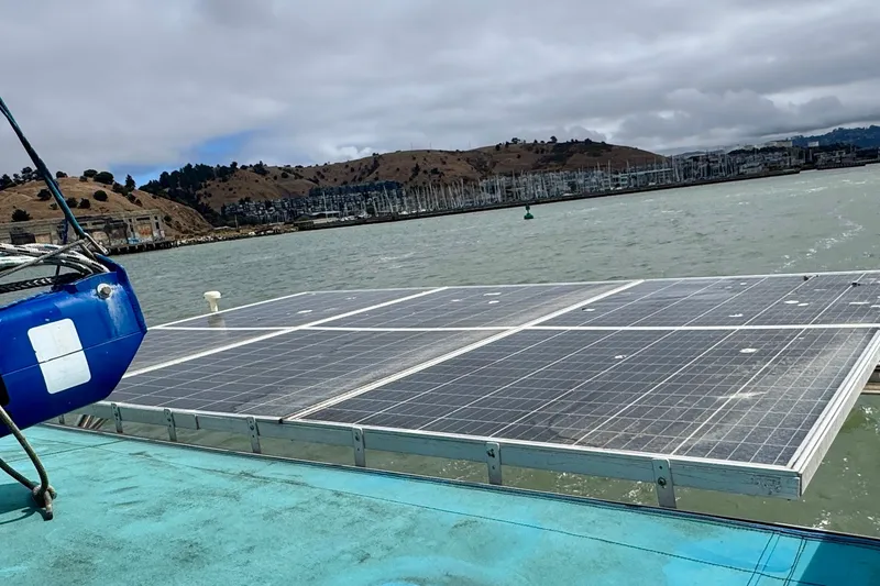Slide: The Image of Solar panels on a St Francis 44 catamaran, 2000 model, with scenic coastal backdrop. - 63