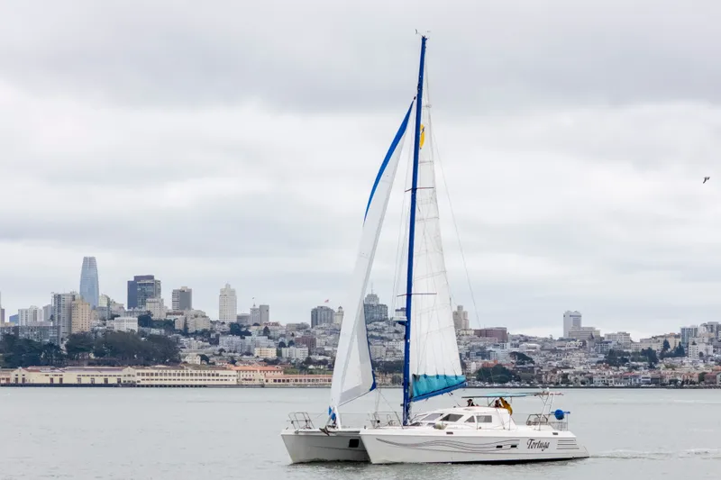 Slide: The Image of Catamaran sailing near city skyline, St Francis 44, 2000 model. - 1