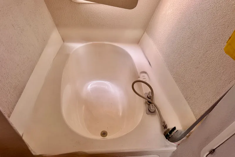 Slide: The Image of Small bathtub with handheld shower in a 2000 St Francis 44 model. - 18