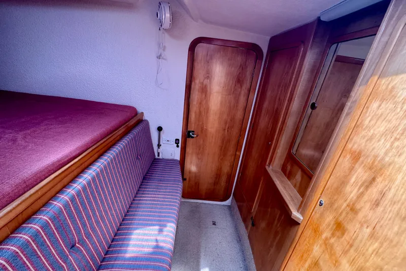 Slide: The Image of Cozy cabin interior of 2000 St Francis 44 yacht with wooden finishes and striped seating. - 22