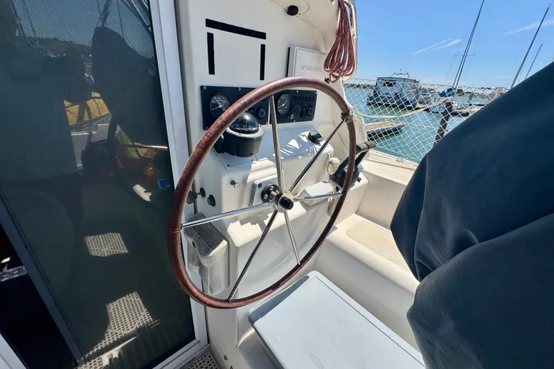 Slide: The Image of Steering wheel of a 2000 St Francis 44 yacht, docked at a marina. - 47