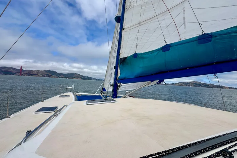 Slide: The Image of Sailing on a 2000 St Francis 44 catamaran with scenic coastal views and blue skies. - 60