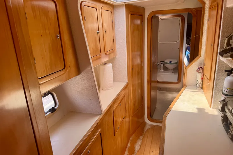 Slide: The Image of Interior of 2000 St Francis 44 yacht with wooden cabinets and a visible bathroom. - 41
