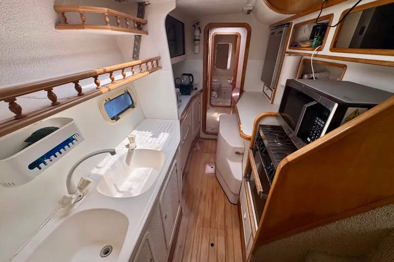 Slide: The Image of Interior of 2000 St Francis 44 yacht with kitchen amenities and wooden accents. - 27