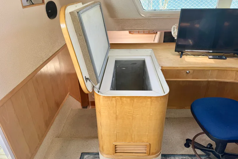 Slide: The Image of Open freezer in a St Francis 44 yacht interior, with a TV and chair nearby. - 16