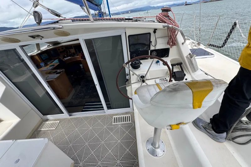 Slide: The Image of Cockpit of a 2000 St Francis 44 sailboat with steering wheel and navigation equipment. - 48