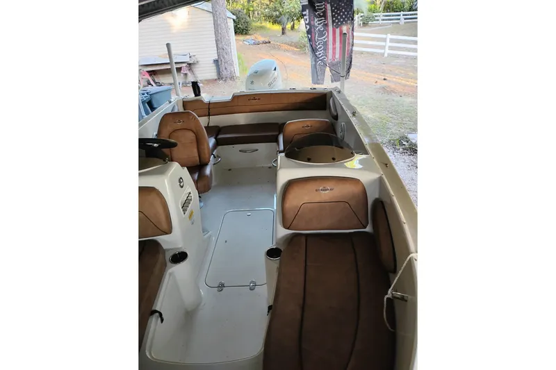 Slide: The Image of 2021 Stingray 172 SC boat interior with brown seating and steering wheel. - 3