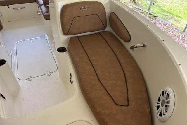Slide: The Image of 2021 Stingray 172 SC boat interior with brown seating and cup holders. - 23
