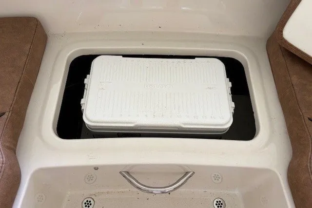 Slide: The Image of A white cooler is placed in a built-in compartment on a boat. - 25