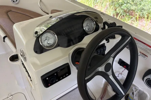 Slide: The Image of 2021 Stingray 172 SC boat dashboard with steering wheel and instrument panel. - 24