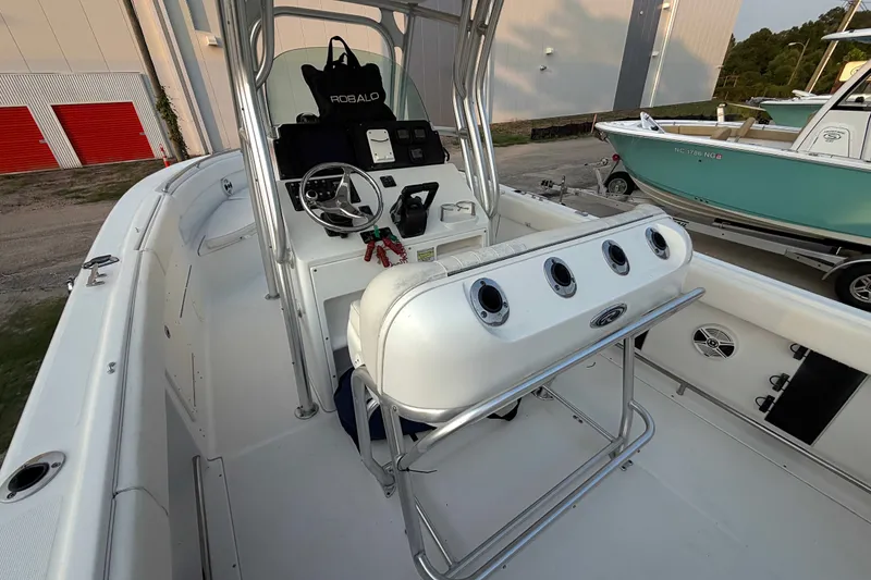 Slide: The Image of 2013 Robalo R260 Center Console boat interior with steering wheel and rod holders. - 31
