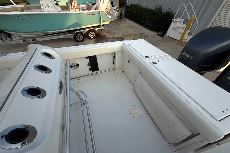 Slide: The Image of 2013 Robalo R260 Center Console boat interior with rod holders and seating. - 30