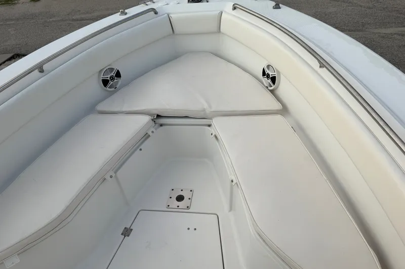 Slide: The Image of 2013 Robalo R260 Center Console boat interior with cushioned seating and speakers. - 15