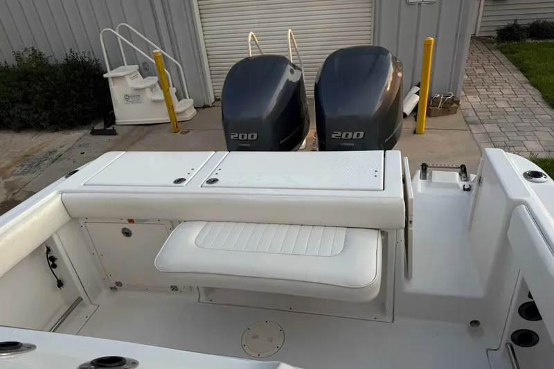 Slide: The Image of 2013 Robalo R260 Center Console boat with twin 200 horsepower engines, docked outdoors. - 27