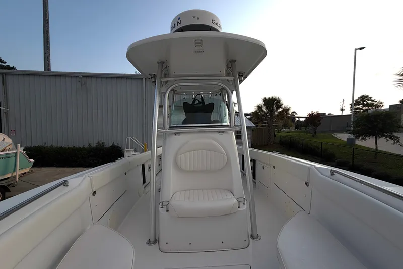 Slide: The Image of 2013 Robalo R260 Center Console boat with white seating and canopy. - 18