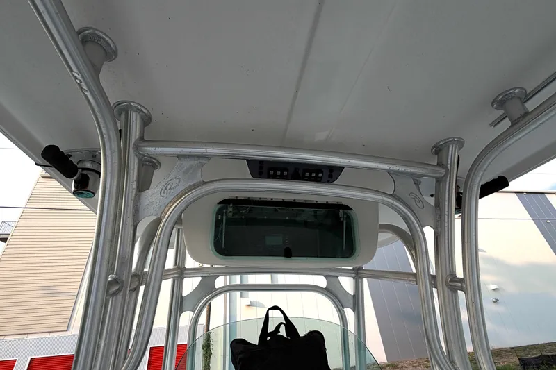 Slide: The Image of 2013 Robalo R260 Center Console boat's T-top frame and electronics enclosure. - 24