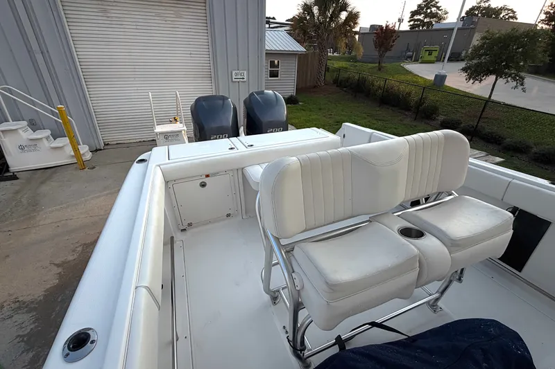 Slide: The Image of 2013 Robalo R260 Center Console boat with dual engines and white seating. - 25