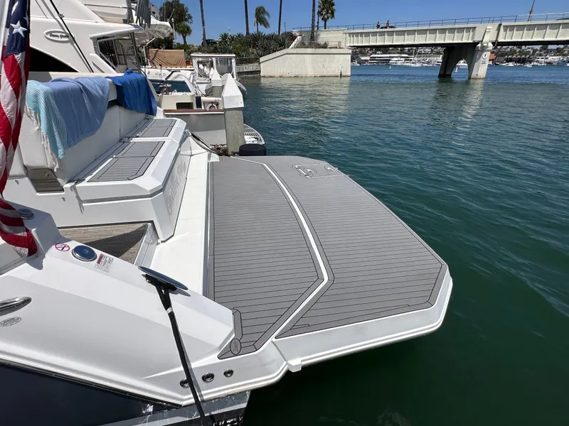 Slide: The Image of The 2018 Cruisers Yachts 390 Express Coupe is docked with a large swim platform. - 7
