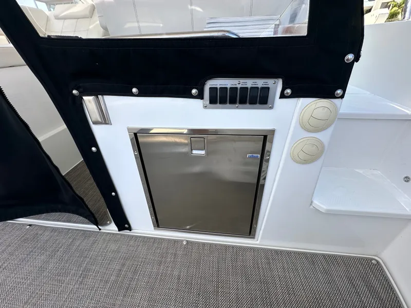 Slide: The Image of The 2018 Cruisers Yachts 390 Express Coupe features a stainless steel fridge door and control panel. - 48