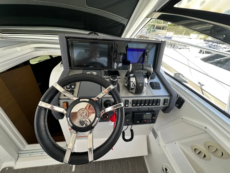 Slide: The Image of The cockpit of a 2018 Cruisers Yachts 390 Express Coupe with modern steering and electronics. - 44