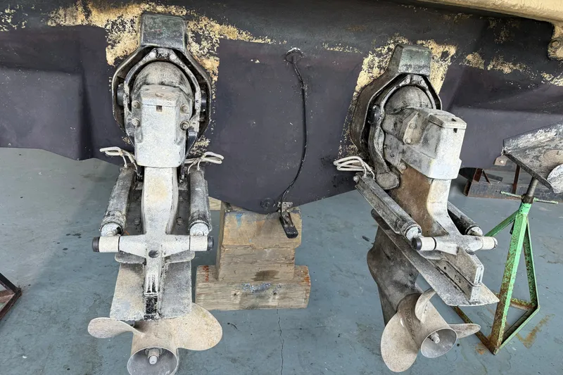 Slide: The Image of 1998 Sea Ray 290 Sundancer boat outdrives on dry dock for maintenance. - 27