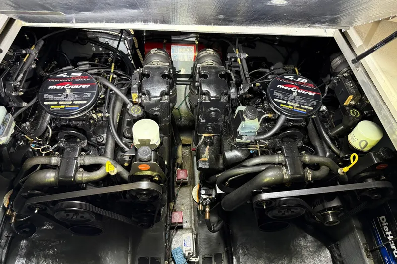 Slide: The Image of Two MerCruiser engines in the engine room of a 1998 Sea Ray 290 Sundancer. - 26