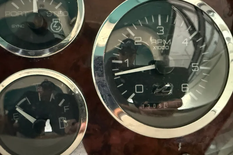 Slide: The Image of Close-up of 1998 Sea Ray 290 Sundancer boat gauges, showing RPM and fuel levels. - 16
