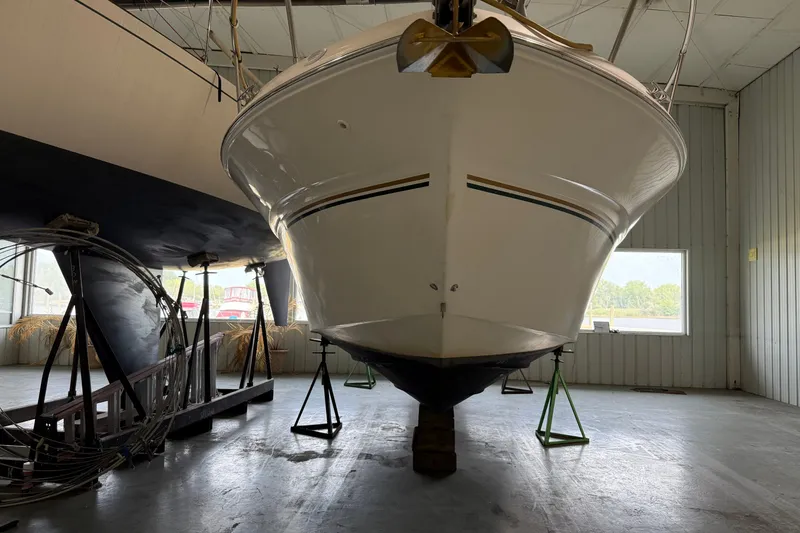 Slide: The Image of 1998 Sea Ray 290 Sundancer boat in storage, elevated on stands in a warehouse. - 2