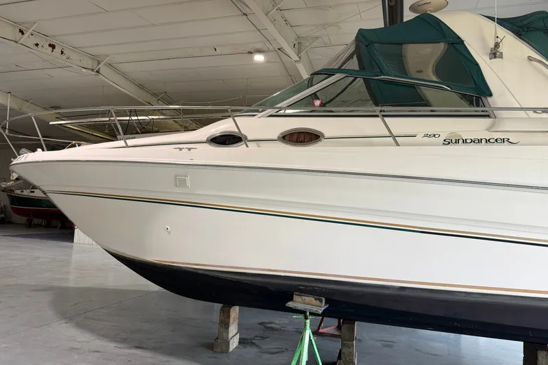 Slide: The Image of 1998 Sea Ray 290 Sundancer boat in indoor storage, side view. - 1