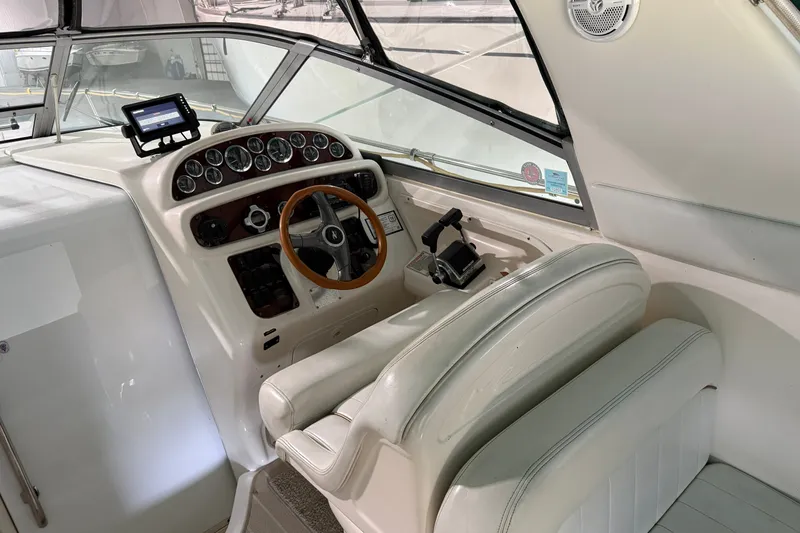 Slide: The Image of 1998 Sea Ray 290 Sundancer helm with steering wheel and control panel. - 8