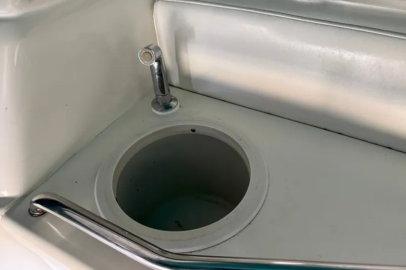 Slide: The Image of 1998 Sea Ray 290 Sundancer boat sink with chrome faucet and cup holder. - 11