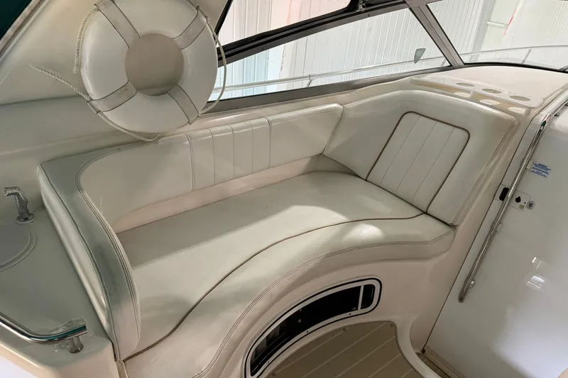 Slide: The Image of 1998 Sea Ray 290 Sundancer interior with white seating and life preserver. - 12