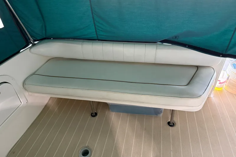 Slide: The Image of Interior seating of a 1998 Sea Ray 290 Sundancer boat with teal canopy. - 10