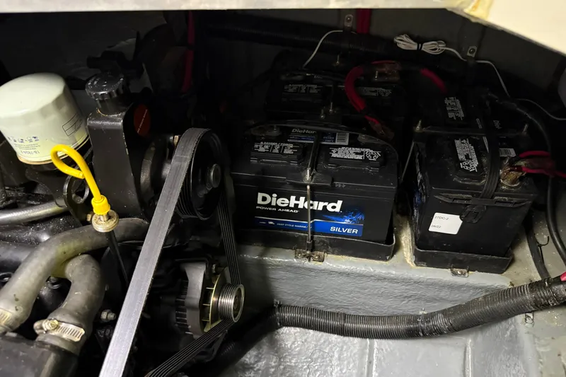 Slide: The Image of Engine compartment of a 1998 Sea Ray 290 Sundancer with DieHard marine batteries. - 25