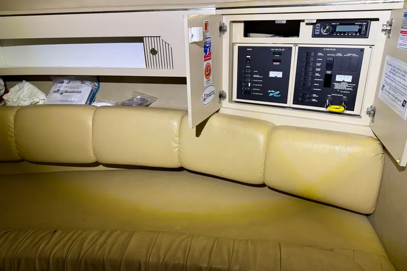 Slide: The Image of 1998 Sea Ray 290 Sundancer cabin interior with beige seating and control panel. - 19