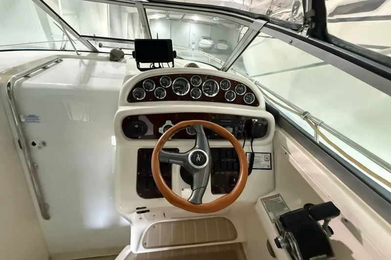 Slide: The Image of 1998 Sea Ray 290 Sundancer helm with wooden steering wheel and instrument panel. - 7