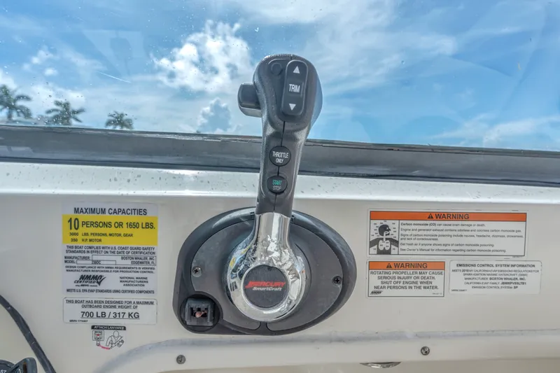 Slide: The Image of Control panel of a 2018 Boston Whaler 230 Vantage boat with capacity warnings. - 27
