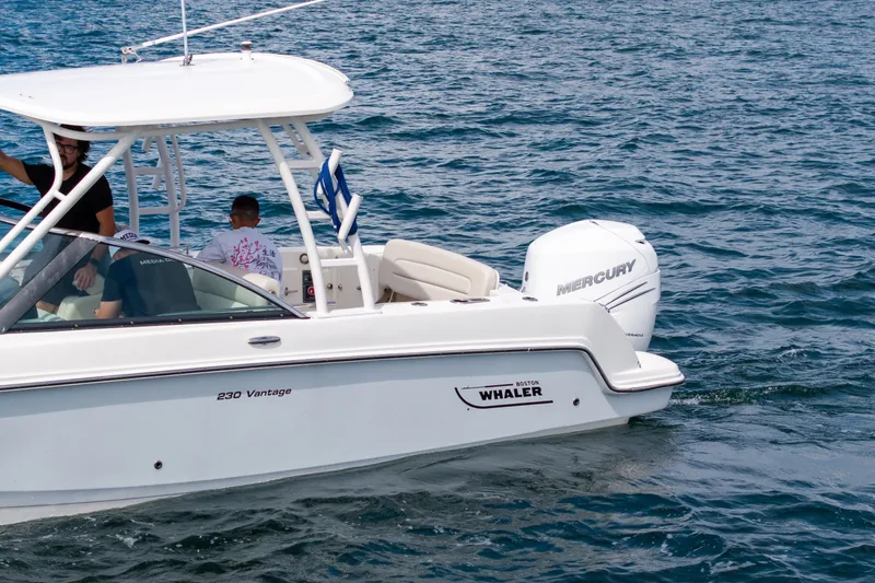 Slide: The Image of 2018 Boston Whaler 230 Vantage boat cruising on open water. - 11