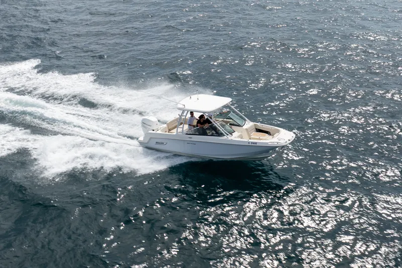 Slide: The Image of 2018 Boston Whaler 230 Vantage cruising on open water, showcasing sleek design and performance. - 7