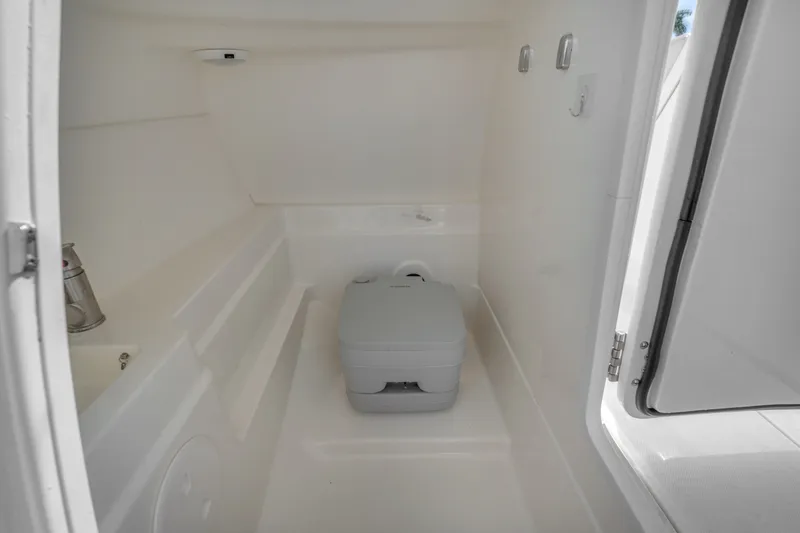 Slide: The Image of 2018 Boston Whaler 230 Vantage interior with compact marine toilet. - 32