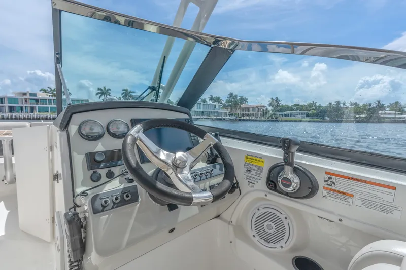 Slide: The Image of Cockpit view of 2018 Boston Whaler 230 Vantage boat with steering wheel and controls. - 23