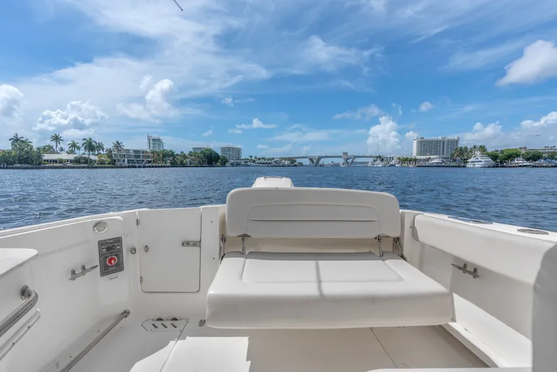 Slide: The Image of 2018 Boston Whaler 230 Vantage boat interior with scenic waterfront view. - 16