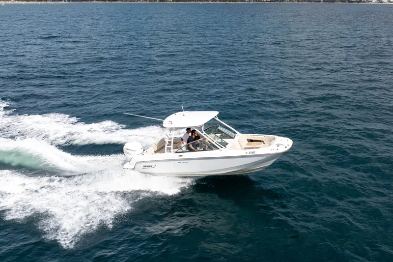 Slide: The Image of 2018 Boston Whaler 230 Vantage cruising on open water. - 9