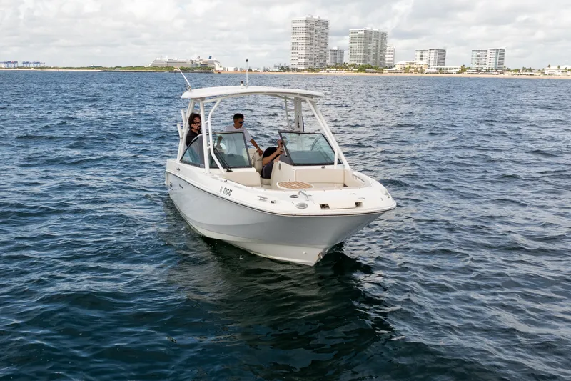 Slide: The Image of 2018 Boston Whaler 230 Vantage boat cruising on open water near city skyline. - 3