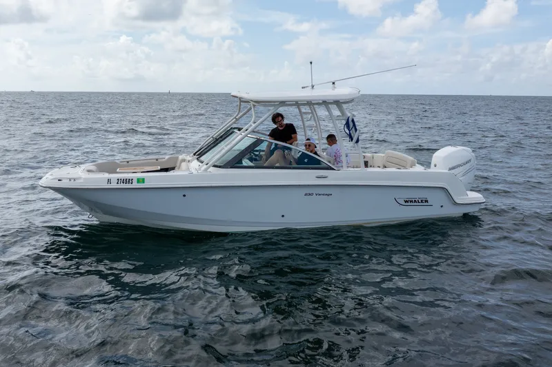 Slide: The Image of 2018 Boston Whaler 230 Vantage boat cruising on open water with passengers onboard. - 1