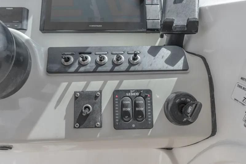 Slide: The Image of Control panel of a 2018 Boston Whaler 230 Vantage boat with switches and ignition. - 28