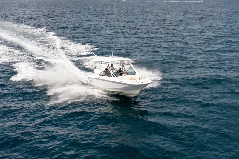 Slide: The Image of 2018 Boston Whaler 230 Vantage cruising on open water, creating a wake. - 8