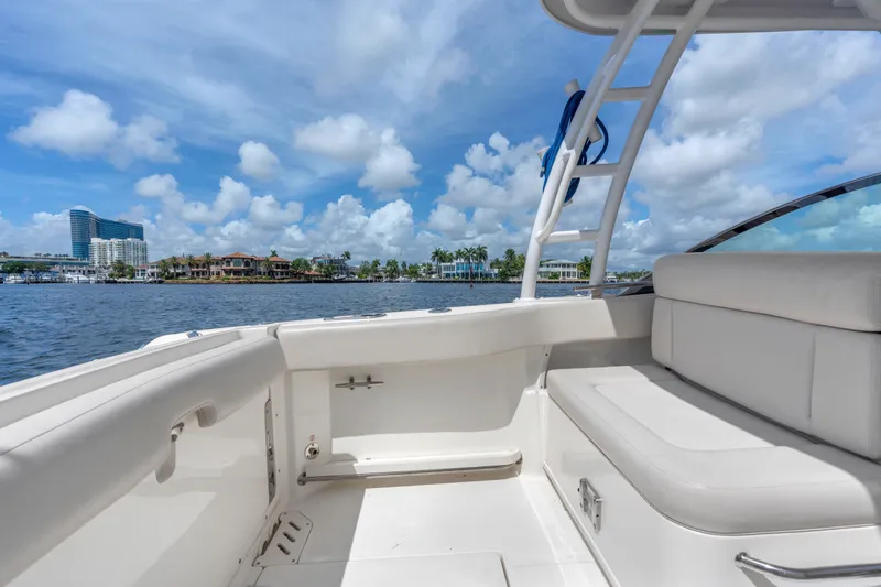 Slide: The Image of 2018 Boston Whaler 230 Vantage boat interior with waterfront view and blue sky. - 14