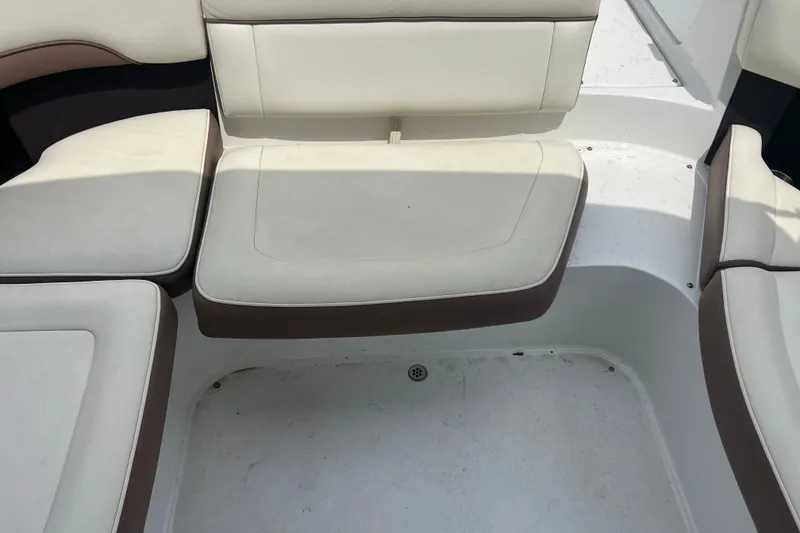 Slide: The Image of Interior seating of a 2012 Cobalt 220 boat with white and brown cushions. - 14