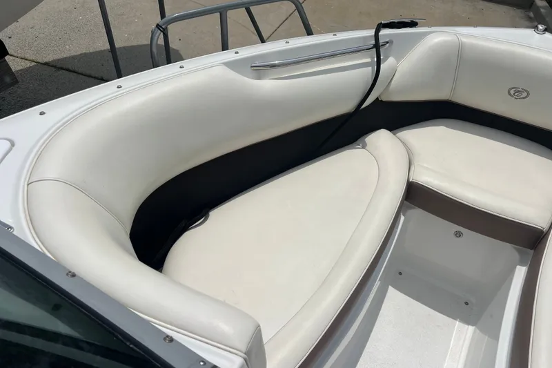 Slide: The Image of 2012 Cobalt 220 boat interior with white cushioned seating. - 18
